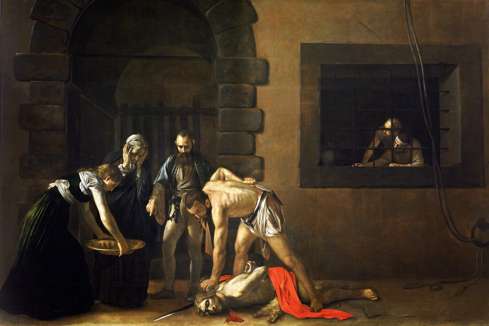 Caravaggio's The Beheading of Saint John the Baptist: an executioner bending over the fallen saint in a dim prison courtyard, with a woman holding a golden dish and two prisoners at a barred window